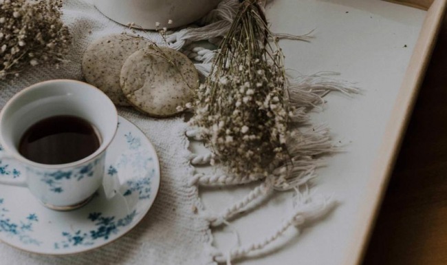 tea and cookies on a serving tray with baby's breath